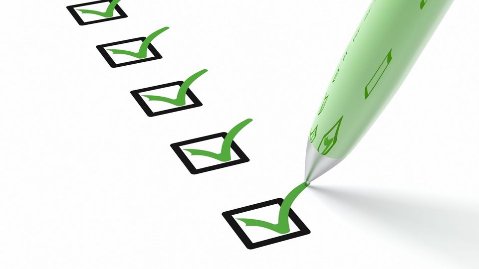 An illustration of 5 ticks in black boxes and a green pen marking the last tick