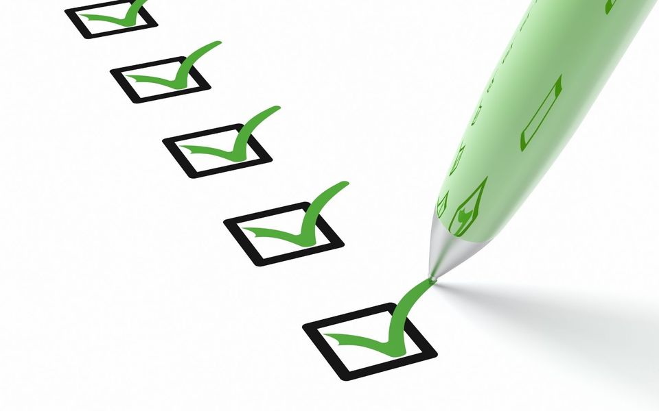 An illustration of 5 ticks in black boxes and a green pen marking the last tick